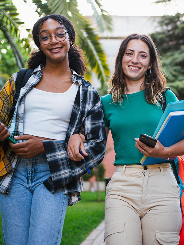 Two young college students walking to class